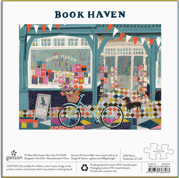 A colorful jigsaw puzzle titled 'Book Haven' by Galison, featuring a charming bookstore exterior with a bike and a dog in front. The artwork shows bright window displays filled with books and flower arrangements. The puzzle consists of 1000 pieces and has a finished size of 27 x 20 inches.