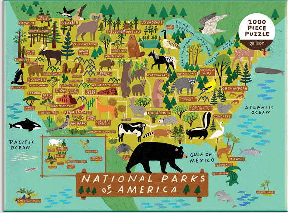 A colorful 1000-piece jigsaw puzzle depicting a map of the National Parks of America, featuring various animals and notable parks such as Yellowstone, Yosemite, and Grand Canyon. The illustration includes forests, mountains, and bodies of water, showcasing the diverse American landscape.