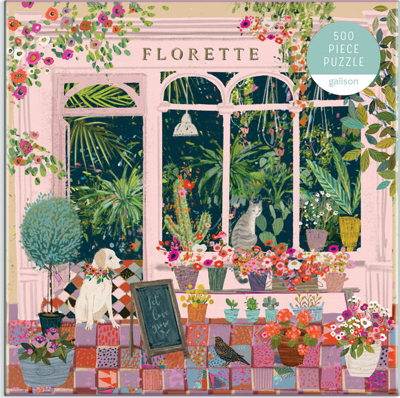 A colorful jigsaw puzzle titled 'Florette' featuring a charming scene of a pet-friendly flower shop. The illustration includes an array of potted plants, vibrant flowers, a white dog wearing a floral collar, and a striped cat, all set against a backdrop with large windows. The puzzle consists of 500 pieces, ideal for both adults and older children, encouraging creativity and relaxation.