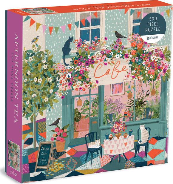 Afternoon Tea Jigsaw Puzzle by Galison featuring a colorful cafe scene with blooming flowers, playful cats, and a cozy outdoor seating area. The box displays vibrant illustrations with a charming ambiance, inviting puzzlers to unwind and enjoy assembling the 500 pieces.