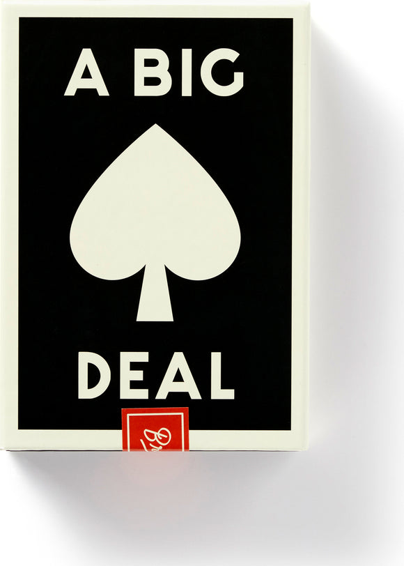 A Big Deal Giant Playing Cards by Chronicle Books displayed in a playful and bold design, featuring a prominent black background with white text and a central spade icon. Ideal for gatherings and game nights, these oversized cards promise fun and entertainment.