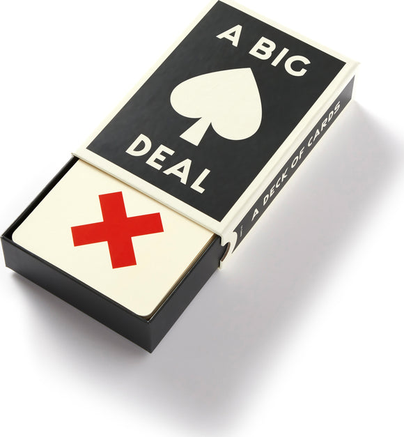 A Big Deal Giant Playing Cards from Chronicle Books. The product features a sleek, stylish packaging with a large black spade symbol and the text 'A BIG DEAL' prominently displayed. The box contains oversized playing cards with a vibrant red cross design on one side, perfect for gatherings and family game nights.