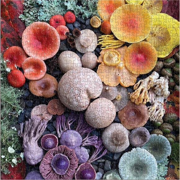 A vibrant jigsaw puzzle featuring an array of colorful mushrooms arranged among foliage and natural elements. The puzzle showcases various shapes and colors of mushrooms, including shades of red, orange, yellow, and purple. The intricacy of the puzzle highlights the beauty of these fungi in an artistic composition.