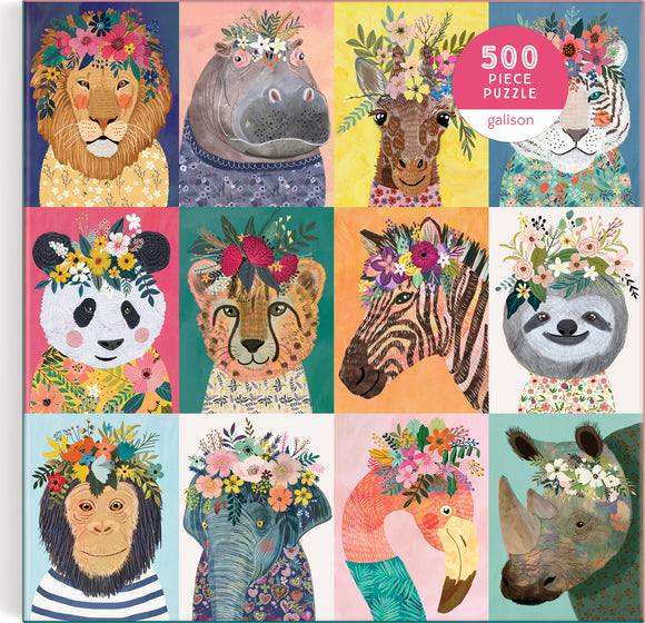 Colorful 500-piece jigsaw puzzle titled 'Wild Spirit' by Galison, featuring adorable animal illustrations with floral crowns. Animals depicted include a lion, hippo, giraffe, tiger, panda, lion cub, zebra, sloth, monkey, elephant, flamingo, and rhino, all adorned with vibrant flowers against bright background colors.