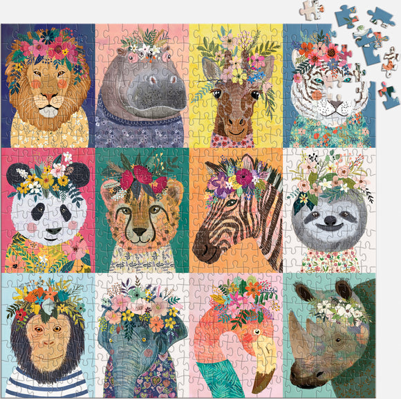 A colorful jigsaw puzzle titled 'Wild Spirit' featuring illustrated portraits of various animals, including a lion, hippopotamus, giraffe, tiger, panda, lion cub, zebra, sloth, monkey, elephant, flamingo, and rhinoceros, each adorned with floral crowns. The puzzle pieces are colorful and intricately designed, creating a vibrant and whimsical scene.