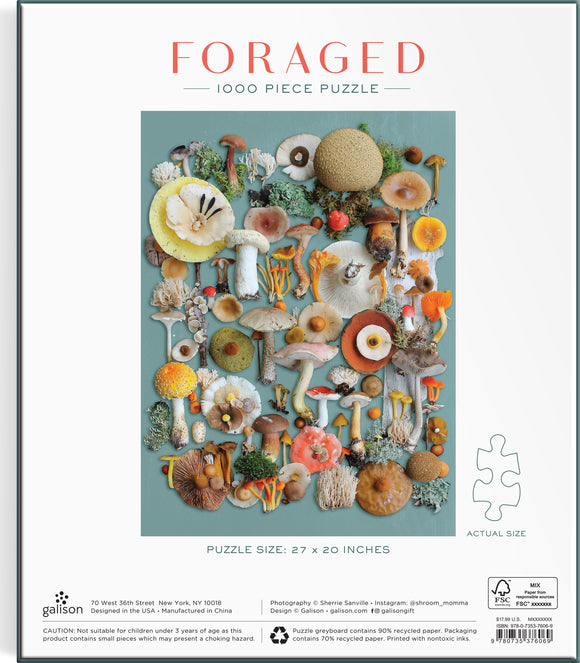 Galison Foraged 1000 Piece Jigsaw Puzzle featuring a vibrant assortment of mushrooms and botanical elements arranged artfully against a teal background. The puzzle size is 27 x 20 inches, providing a challenging and visually appealing experience for puzzle enthusiasts.
