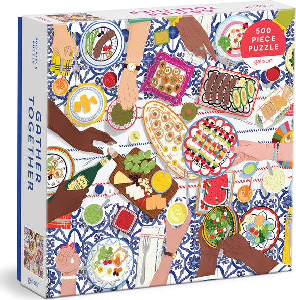Gather Together jigsaw puzzle featuring an overhead view of a beautifully set table filled with diverse dishes, hands reaching in to share food, and vibrant colors. This 500-piece puzzle by Galison captures the essence of community and feasting together, making it a perfect gift for puzzle lovers and those who enjoy a fun, engaging challenge.