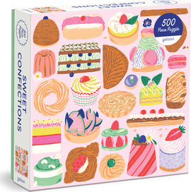 A colorful jigsaw puzzle titled 'Sweet Confections' by Galison, featuring an assortment of illustrated desserts like cakes, pastries, and candies on a pink background. The box contains 500 pieces, showcasing vibrant artwork that captures the essence of delightful sweets.