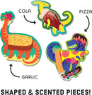 The Scratch and Sniff Pizzasaurus jigsaw puzzle features vibrant, colorful dinosaur-shaped pieces, including a dinosaur with a pizza slice, a cola-themed dinosaur, and a garlic-themed dinosaur. Each piece offers a unique scent, promising an engaging and interactive puzzle experience.