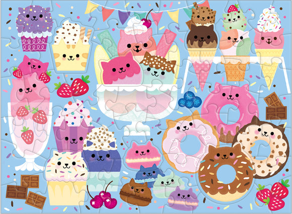 A colorful jigsaw puzzle featuring cartoon cats shaped like ice cream, cupcakes, and donuts against a light blue background. The puzzle showcases an assortment of desserts with playful, cute designs, including strawberries and sprinkles.