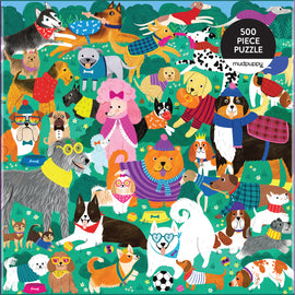 Colorful jigsaw puzzle featuring a playful assortment of cartoon-style dogs in various outfits and accessories, set against a vibrant green background with flowers. The puzzle consists of 500 pieces and is designed by Mudpuppy, perfect for dog lovers of all ages.