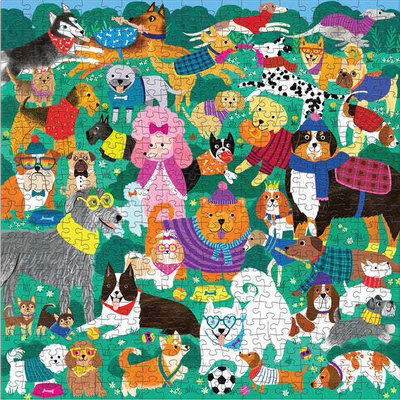 Doggone Days 500pc jigsaw puzzle by Mudpuppy featuring a colorful collage of various dogs in playful poses, wearing sweaters and accessories amidst a green backdrop with flowers.