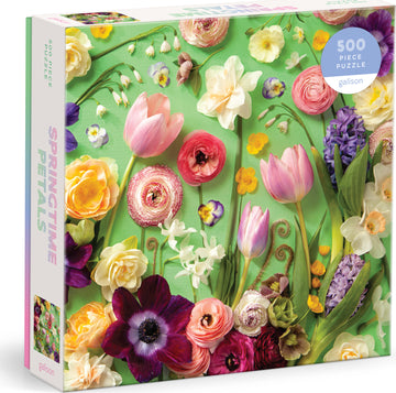 Springtime Petals 500-piece jigsaw puzzle by Galison featuring a vibrant array of flowers including tulips, ranunculus, and daffodils on a green background. The packaging showcases the colorful floral design, highlighting the beauty of spring.