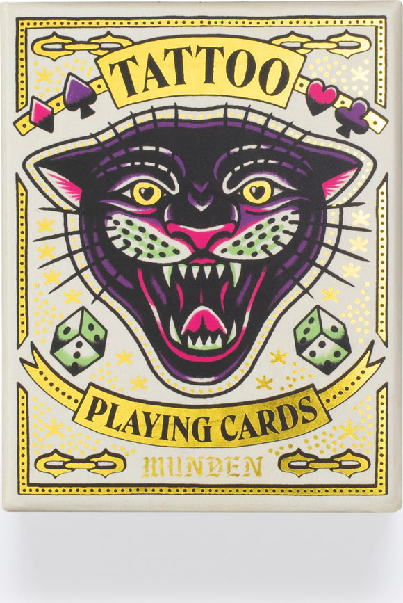 Tattoo Playing Cards by Chronicle Books featuring a vibrant and artistic design of a snarling black panther with gold and colorful accents. The packaging showcases playful illustrations including dice and decorative elements, combining classic playing card aesthetics with a tattoo-inspired theme.