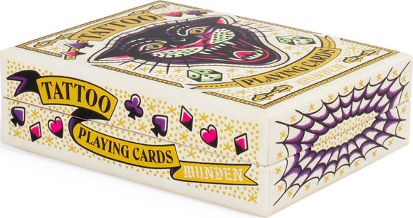 A colorful box of Tattoo Playing Cards by Chronicle Books, featuring a striking design of a black panther with green eyes. The box includes playful elements like dice and decorative symbols in a vibrant mix of colors, perfect for adding a unique flair to game nights.