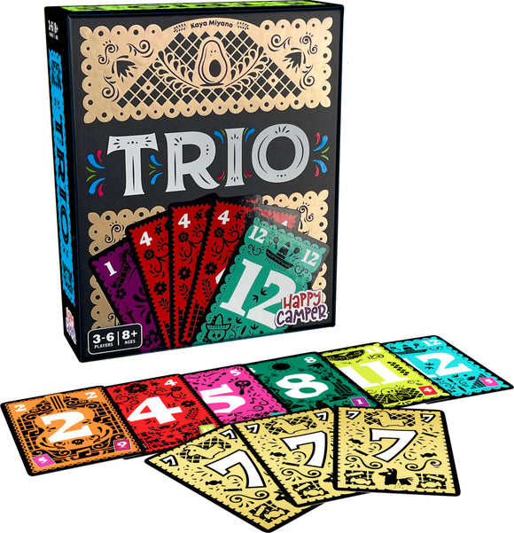 The game 'Trio' by Happy Camper features a colorful box design with intricate patterns and illustrations. The game cards include numbers and vibrant colors, displayed spread out below the box, highlighting gameplay elements. Suitable for 3 to 6 players aged 8 and above.