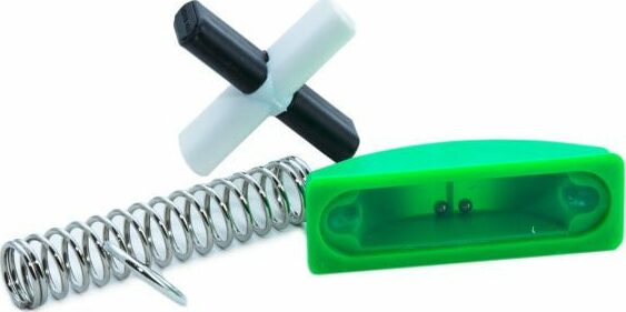 One Second puzzles by House of Marbles featuring a colorful mechanical puzzle accessory set. The image showcases a green puzzle piece holder, a spring component, and a black and white cross connector, ideal for puzzle enthusiasts looking for a fun challenge.