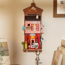 The Love Post Office DIY kit by Robotime features an intricately designed miniature post office. It showcases vibrant colors with details like a red postal office, a welcoming sign, various postal items, and a charming character. Perfect for crafting enthusiasts, this kit adds a decorative touch to any space.