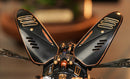 A detailed close-up of the Stag Beetle DIY kit from Robotime, showcasing its intricately designed black and copper wings. The wings feature decorative vents and a mechanical assembly, embodying a fusion of art and engineering, ideal for hobbyists and nature enthusiasts. The background is softly blurred, highlighting the craftsmanship of the kit.