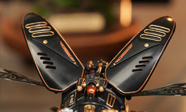 A detailed close-up of the Stag Beetle DIY kit from Robotime, showcasing its intricately designed black and copper wings. The wings feature decorative vents and a mechanical assembly, embodying a fusion of art and engineering, ideal for hobbyists and nature enthusiasts. The background is softly blurred, highlighting the craftsmanship of the kit.