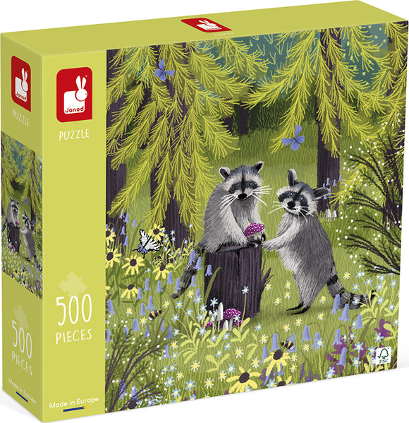 Colorful jigsaw puzzle box featuring two adorable raccoons sharing a mushroom in a vibrant forest setting filled with flowers and butterflies. This 500-piece puzzle is made by Janod.