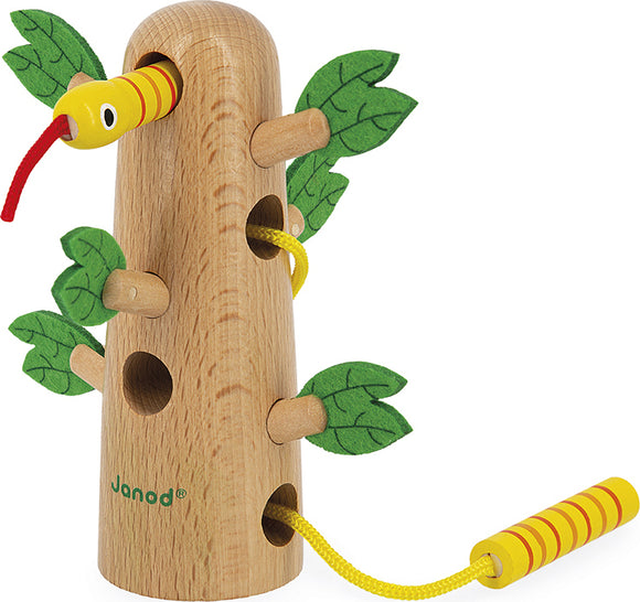 The Tropik Tropical Lace Up Tree by Janod features a wooden tree structure adorned with colorful leaves. The playful design includes a winding snake with a red tongue that weaves through holes in the tree, promoting fine motor skills in children.