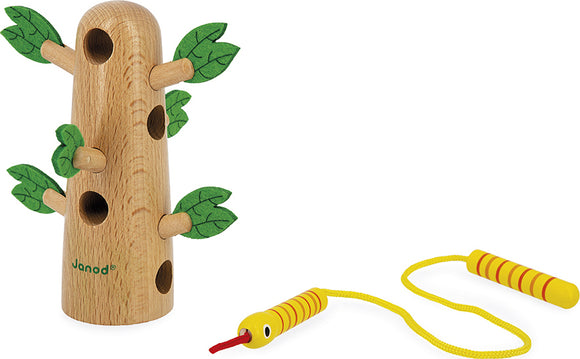 Tropik Tropical Lace Up Tree by Janod, featuring a wooden tree structure with multiple holes and green leaves. Accompanied by a colorful yellow snake lacing toy, designed for creative play and motor skills development.