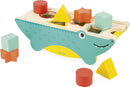 Tropik Shape Sorting Crocodile by Janod, a colorful wooden toy designed for shape sorting with various geometric blocks including stars, triangles, and squares in vibrant colors placed around a crocodile-shaped base, enhancing fine motor skills and cognitive development for toddlers.