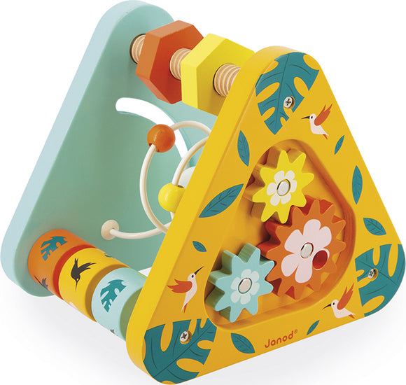 The Janod Tropik Multi-Activity Triangle is a colorful wooden toy with a triangular shape. It features moving gears in bright colors like yellow, orange, pink, and blue, adorned with tropical leaf patterns and playful bird illustrations. The toy includes a rolling cylinder and a wire maze element, designed to keep children engaged while developing fine motor skills and hand-eye coordination.