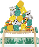 Tropik Balancing Games by Juratoys features colorful wooden pieces shaped like animals, fruits, and leaves, arranged in a playful stack on a wooden base, promoting balance and coordination.