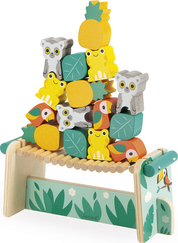 The Tropik Balancing Games by Juratoys features a colorful display of stacked wooden animal and fruit blocks, including cute koalas, frogs, and tropical fruits. This engaging game encourages hand-eye coordination and fine motor skills as players aim to build and balance the fun structures on a sturdy base. The playful design makes it an eye-catching addition to any playroom.