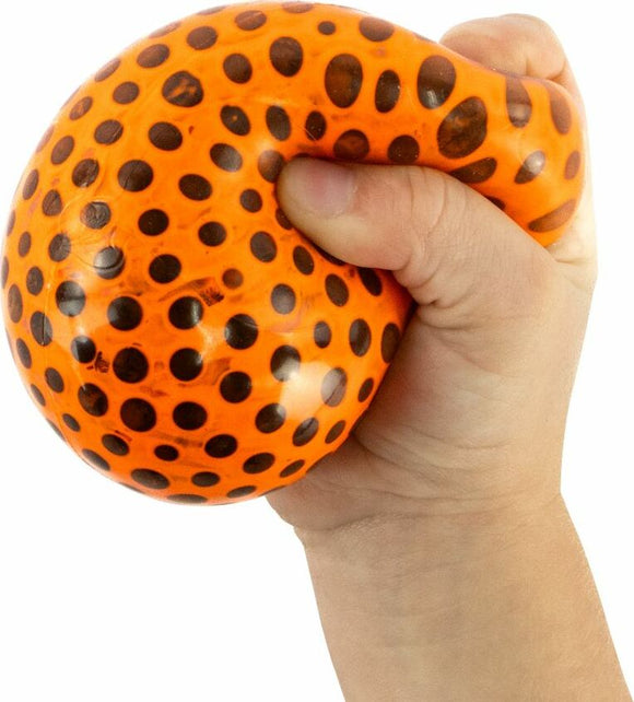 A close-up image of a child squeezing a vibrant orange Beadz Alive Ball covered with black dots. The ball is soft and squishy, ideal for stress relief and sensory play.