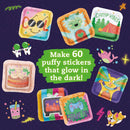 A colorful DIY kit by Klutz titled 'Make Your Own Glow-In-The-Dark' with 60 puffy sticker designs. The stickers include fun illustrations of a happy sun wearing sunglasses, playful animals, and vibrant patterns that glow in the dark, perfect for crafting and personalizing items.