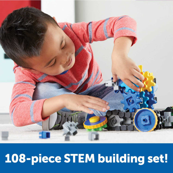 A young child is engaged in building with the Gears! Gears! Gears! Treadmobile DIY kit from Learning Resources. The child is focused on connecting colorful gears and components, showing creativity and engagement in hands-on STEM learning. Surrounding them are various pieces from the 108-piece set, promoting fine motor skills and imaginative play.