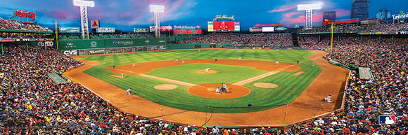 A panoramic view of Fenway Park filled with fans during a Red Sox baseball game. The vibrant green field contrasts with the packed stands under a colorful sunset sky, showcasing the excitement of the game.