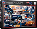 A vibrant jigsaw puzzle from the Gameday Collection depicting a New England Patriots tailgating scene. Focused on a blue pickup truck adorned with Patriots logos, surrounded by footballs, snacks, and festive decorations. Two enthusiastic fans, one wearing a helmet and the other a Patriots hat, showcase team spirit amidst a lively gameday atmosphere. Perfect for NFL fans and puzzle enthusiasts alike.