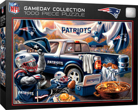 A vibrant jigsaw puzzle from the Gameday Collection depicting a New England Patriots tailgating scene. Focused on a blue pickup truck adorned with Patriots logos, surrounded by footballs, snacks, and festive decorations. Two enthusiastic fans, one wearing a helmet and the other a Patriots hat, showcase team spirit amidst a lively gameday atmosphere. Perfect for NFL fans and puzzle enthusiasts alike.