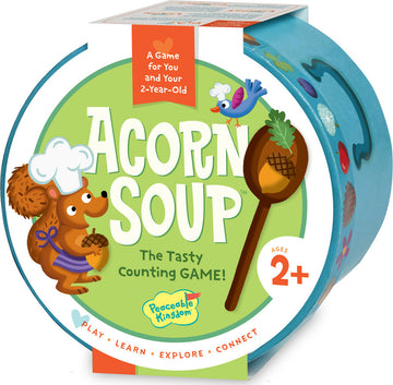 Acorn Soup game by Peaceable Kingdom featuring a cheerful squirrel chef holding an acorn. The packaging is vibrant with playful illustrations including a bird and various colorful ingredients. It promotes counting and is suitable for children aged 2 and up, emphasizing play, learning, exploration, and connection.