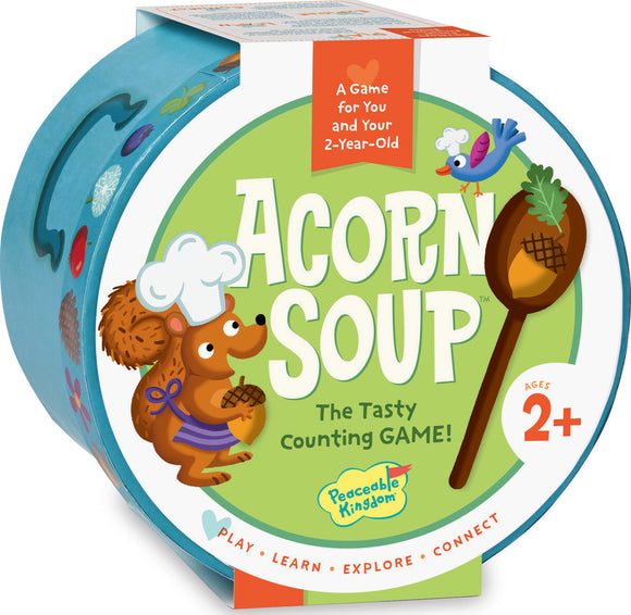 A circular game box for 'Acorn Soup' by Peaceable Kingdom. The box features a friendly cartoon squirrel wearing a chef's hat, holding an acorn. The title 'Acorn Soup' is prominently displayed in bold green letters on a pastel green background. The design is colorful and playful, emphasizing that it's a counting game suitable for children aged 2 and above. It promotes play, learning, and exploration.