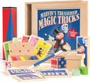 Marvin's Treasured Magic Tricks Wooden Set by Marvin's Magic displayed on a white surface. The set includes colorful cards, a wooden box with holes and colorful blocks, a wand, a red and black magic cylinder, and various other magic trick items. The top of the wooden box features an illustration of a cheerful magician. This complete magic show kit promises fun for all ages, sparking creativity and entertainment.