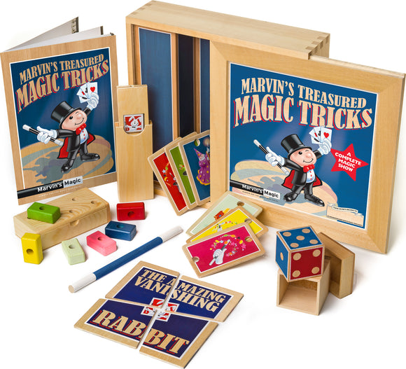 Marvin's Treasured Magic Tricks Wooden Set featuring a colorful box with the title prominently displayed, various wooden magic props including cards, blocks, and a magician's wand, aimed at young aspiring magicians.
