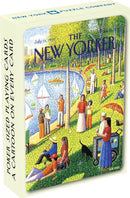 A colorful deck of Fine Arts Cartoon Cards by New York Puzzle Company, featuring a vibrant illustration from The New Yorker. The box showcases a park scene with people enjoying various activities by a lake, emphasizing playful cartoon-style artwork. The cards are designed to be poker-sized with a cartoon on every card.