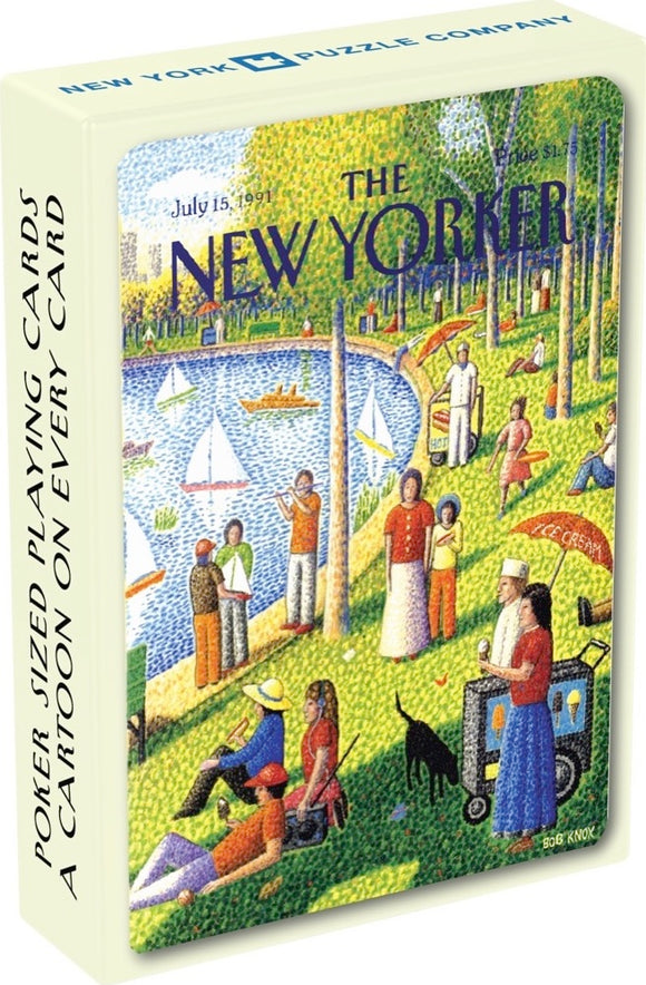 A colorful deck of Fine Arts Cartoon Cards by New York Puzzle Company, featuring a vibrant illustration from The New Yorker. The box showcases a park scene with people enjoying various activities by a lake, emphasizing playful cartoon-style artwork. The cards are designed to be poker-sized with a cartoon on every card.