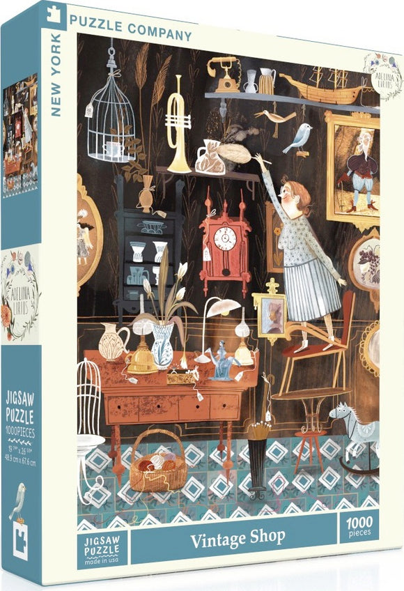 A vintage-themed jigsaw puzzle titled 'Vintage Shop' by New York Puzzle Company, showcasing a cozy antique shop filled with various nostalgic items including a clock, a birdcage, a sewing machine, and more. The scene features a character reaching for a decorative item while several other antiques are displayed around the shop, implying a whimsical atmosphere perfect for puzzle enthusiasts.