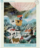 A beautifully illustrated jigsaw puzzle titled 'On a Voyage' by New York Puzzle Company featuring a girl in a hot air balloon surrounded by scenic landscapes. The vibrant colors and whimsical design depict mountains, forests, and charming houses, inviting puzzlers to embark on a captivating journey.