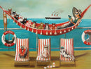 A whimsical jigsaw puzzle featuring a colorful scene of various cats relaxing on a deck, with one cat reading in a hammock, surrounded by ocean and a ship in the background. The playful cats wear sunglasses and float around in life-rings labeled 'MINK'. A vibrant and fun depiction of a sunny day at sea.