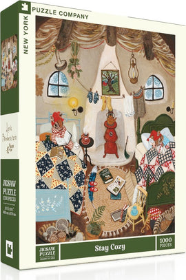 The 'Stay Cozy' jigsaw puzzle by New York Puzzle Company features a cozy indoor scene with two characters wrapped in colorful blankets, surrounded by books, textiles, and decorative items. The warm atmosphere is highlighted by soft lighting, patterned quilts, and a quaint fireplace, evoking a sense of comfort and relaxation. This 1000-piece puzzle invites you to create a delightful depiction of a snug, inviting space.