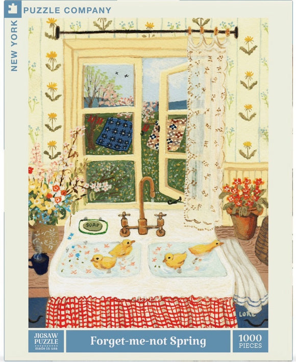 A jigsaw puzzle box featuring the 'Forget-Me-Not Spring' design by New York Puzzle Company. The artwork depicts a sunny kitchen with an open window showing a vibrant spring landscape. Inside, there's a white sink with two yellow ducklings swimming in basins, adorned with a bar of SOAP. Floral wallpaper and fresh flowers on the countertop enhance the cheerful springtime feel. The puzzle consists of 1000 pieces.