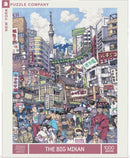 The Big Mikan jigsaw puzzle by New York Puzzle Company features a vibrant and detailed illustration of a bustling urban scene, showcasing a mix of traditional and modern architecture, crowds of people in diverse outfits, and iconic elements such as the Tokyo Skytree and Mount Fuji in the background. This 1000-piece puzzle promises hours of engaging entertainment for puzzle enthusiasts.