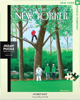 500-piece jigsaw puzzle titled 'My Best Shot,' featuring a vibrant illustration of three men in golf attire observing a golfer in a tree. The artwork, by Bruce McCall, is inspired by the cover of The New Yorker magazine from April 11, 2011. Suitable for puzzle enthusiasts and fans of contemporary art.